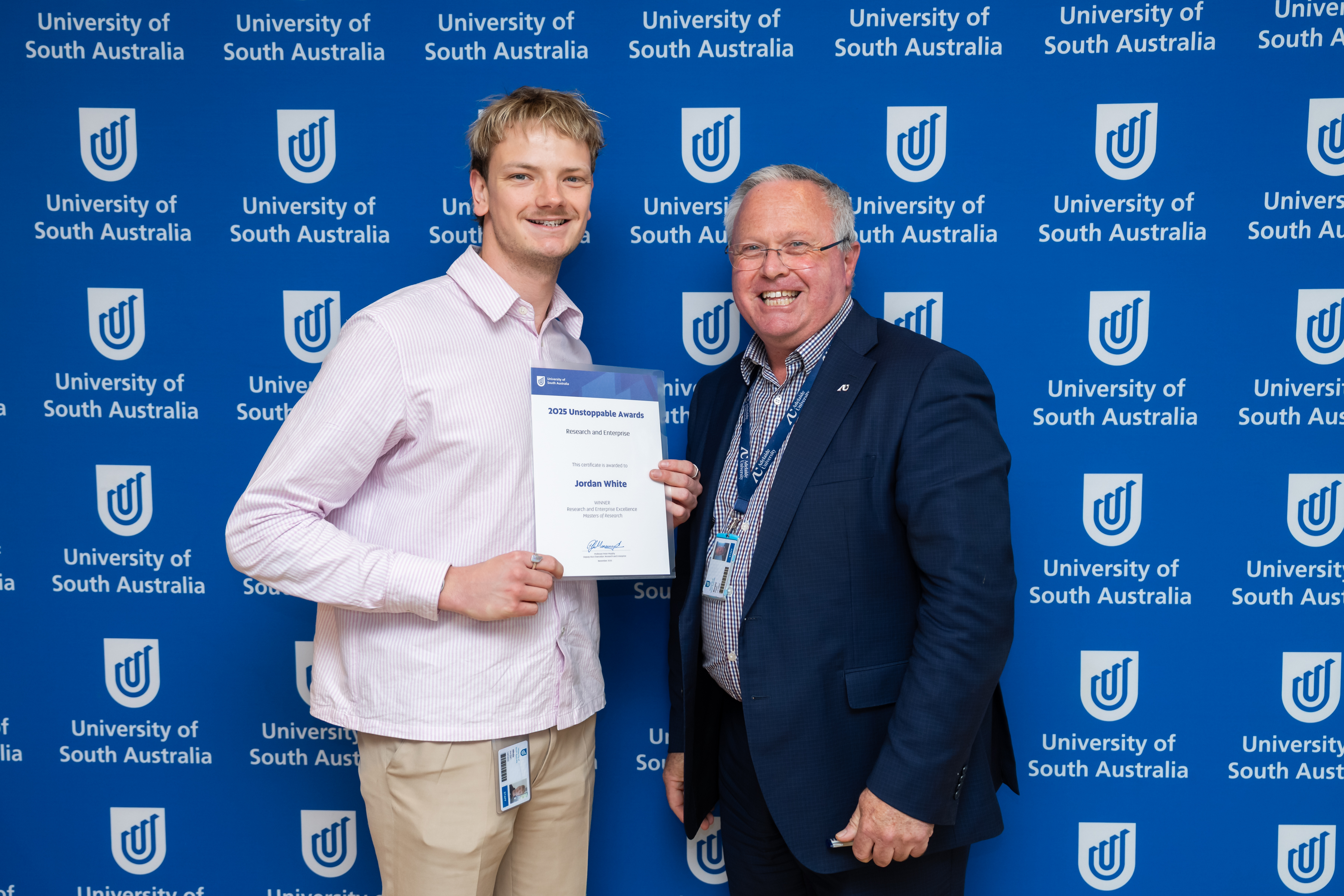 Jordan White is presented the Masters of Research Award by the Deputy Vice Chancellor: Research & Enterprise, Professor Peter Murphy