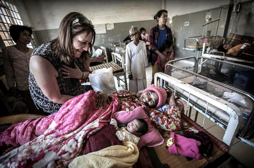 Kate Taylor with a new mum and baby in the antenatal ward, Cambodia