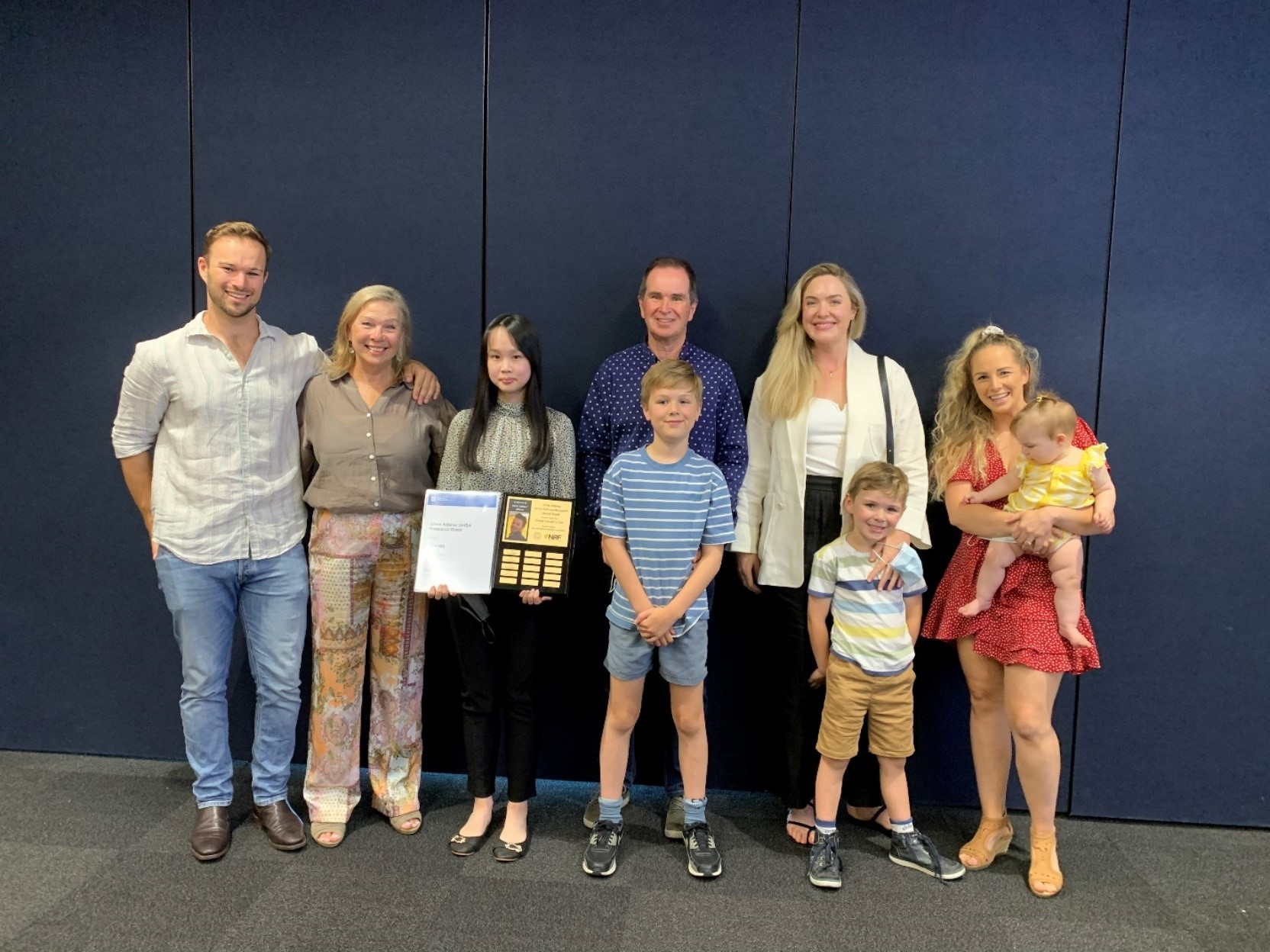 Chris Adams&rsquo;s brother, mother, father, sisters-in-law, niece and nephews at the 2021 Chris Adams UniSA Research Grant presentation with researcher Erica Yeo (second to left).