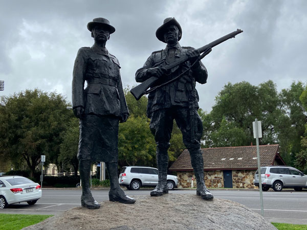 Surrounding the ceremonial centre is a grassy mound on which stand two bronze figures, representing Aboriginal servicemen and women.