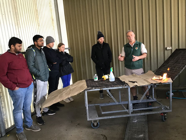 Ian Tanner, Department for Environment and Water fire manager for the Adelaide-Mt Lofty Region using a burn table to explain fire behaviour to students. 