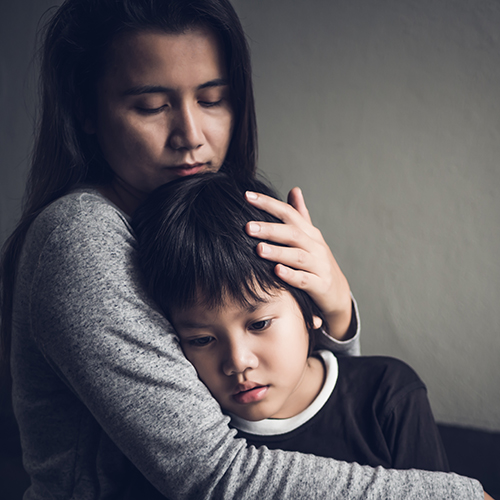 mother hugging sad boy