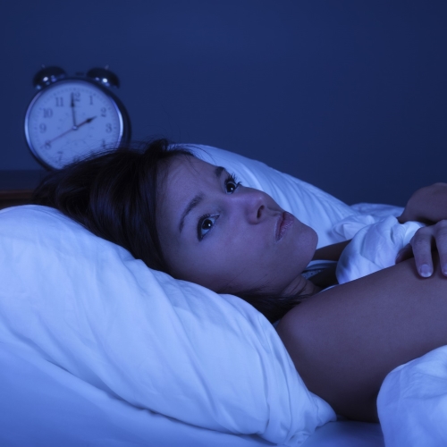 Woman lying awake in bed