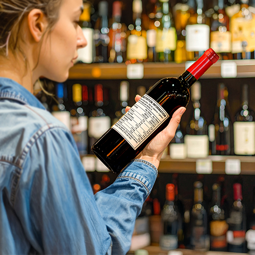 women reading wine label