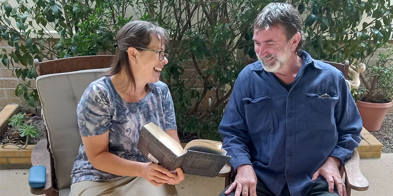 UniSA PhD candidate Elizabeth Wells reading to a family member. Photo: Elliot Robins/author provided, CC BY-SA