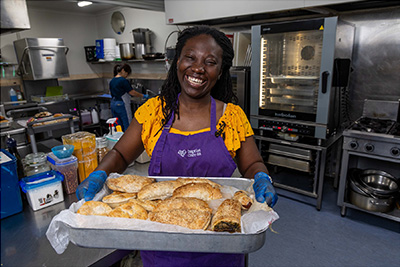 Ruth Appiah volunteering at Baptist Care SA serving breakfast to people in need.