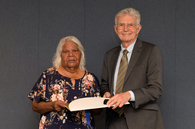 Judy Johnson receiving Kelvin W Johnson&rsquo;s posthumous award from UniSA Chancellor John Hill.